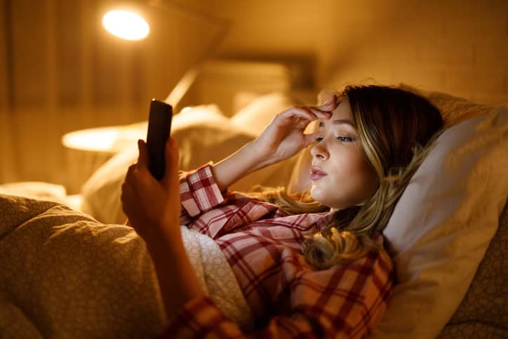 Sad woman reading bad news on mobile