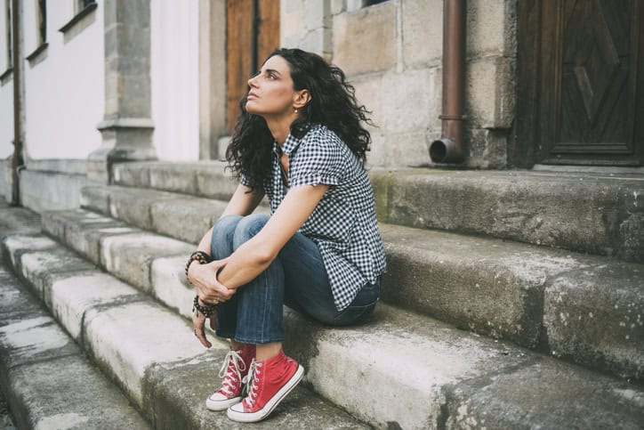 woman sitting alone on steps