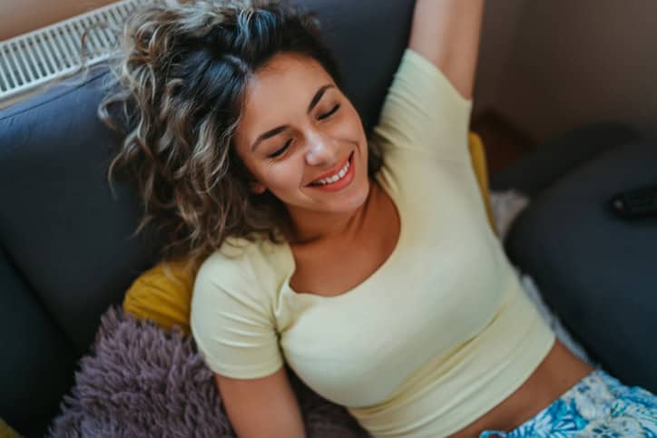 Relaxed young woman lying on the sofa