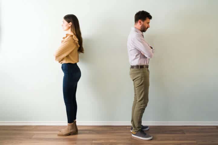 two people standing back to back