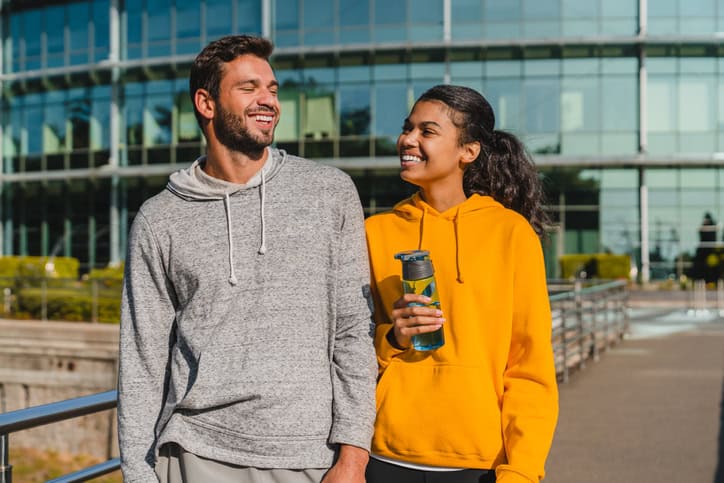 couple in hoodies smiling