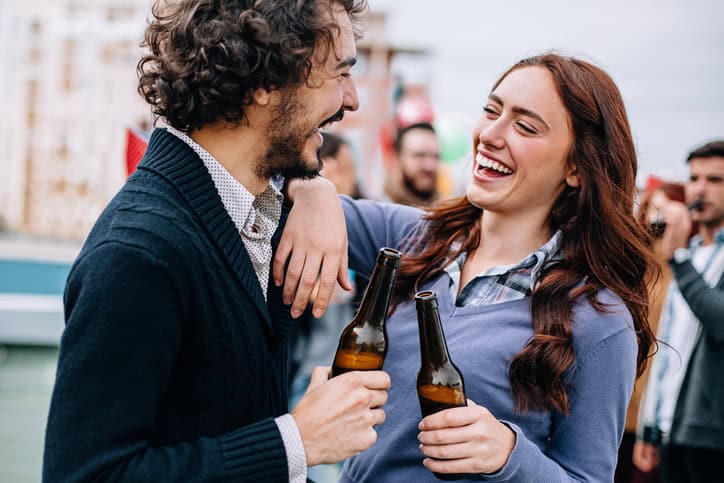 young couple have drinks at party