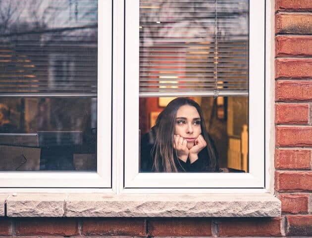sad woman looking out window