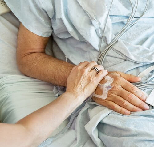 Man in a hospital bed.