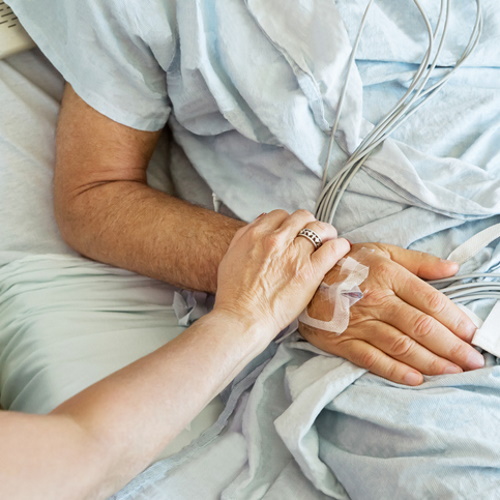 Man in a hospital bed.