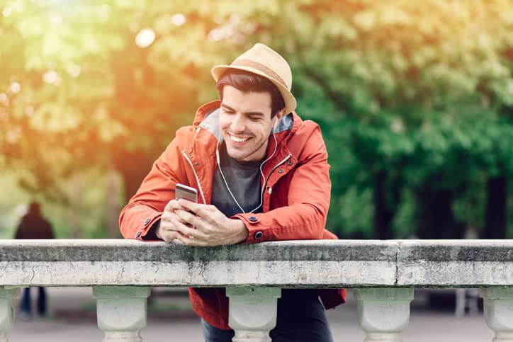 man on a bridge using mobile