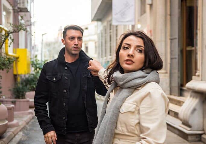 angry girlfriend turning away from boyfriend