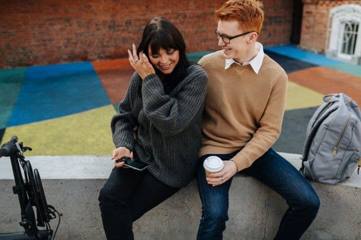 couple flirting on a wall