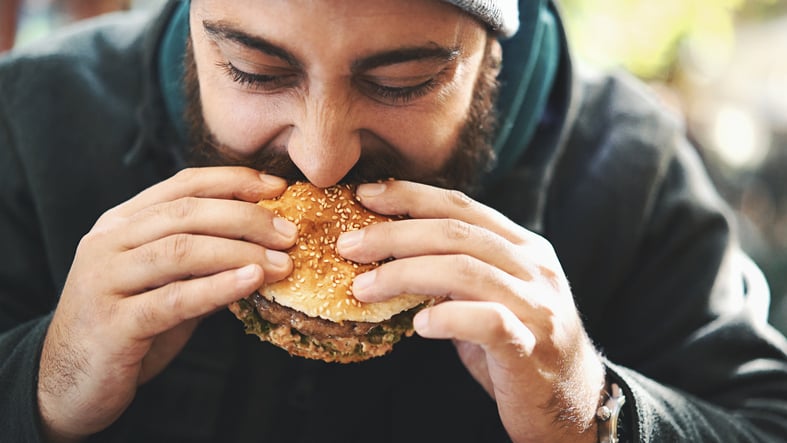 Man eating a burger.