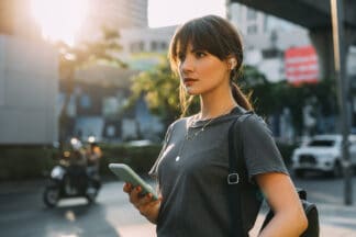 brunette woman in the city texting