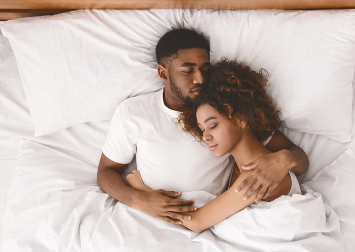 african american laying in bed together