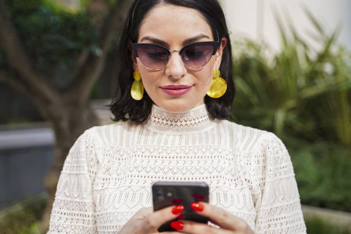 trendy woman holding smart phone