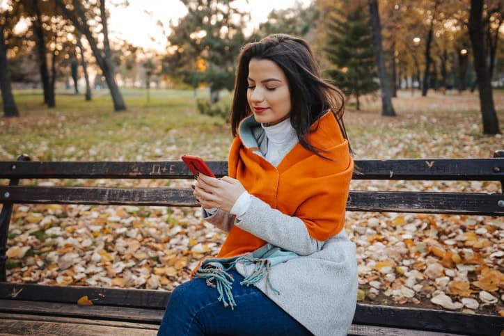 woman outisde autumn leaves