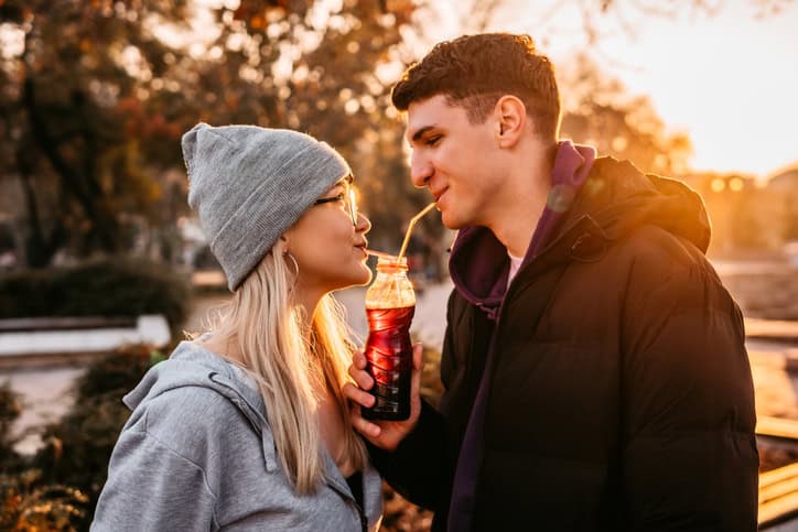 Man and woman sharing a drink.