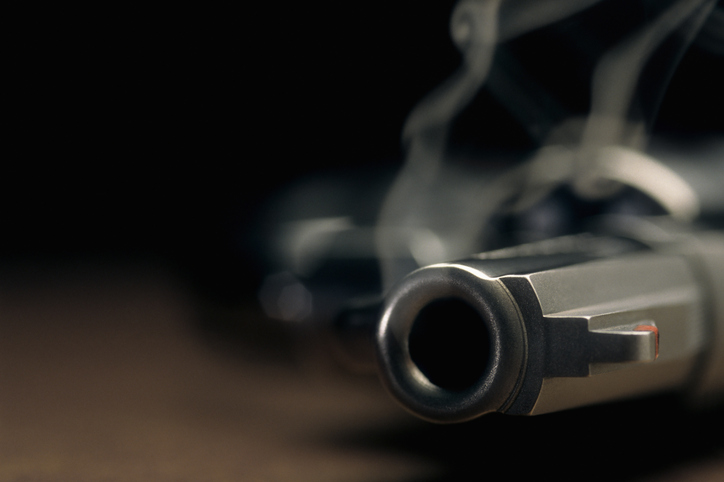 Smoking gun lying on the floor.
