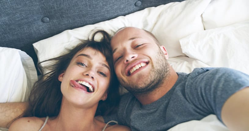 couple being silly laid in bed