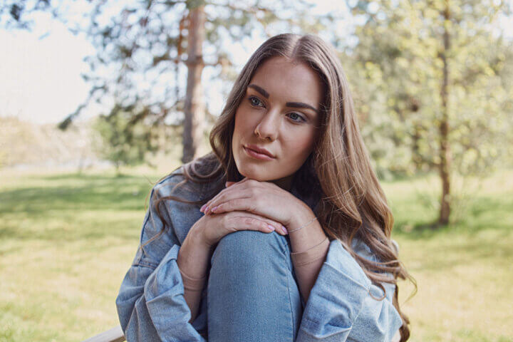 sad woman resting on knees