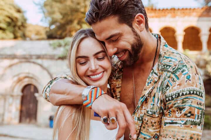 stylish couple smiling hugging
