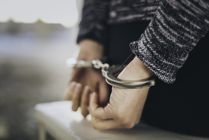 A prisoner in handcuffs.