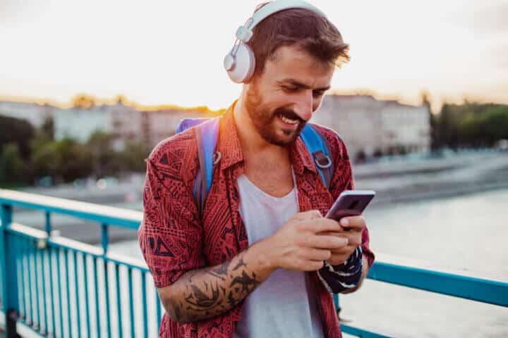 young man outside using mobile