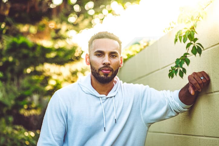 mixed race guy leaning against wall