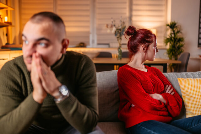 couple looking away from each other on the couch