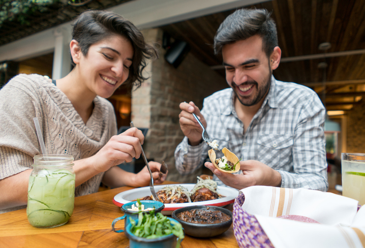 Couple eating Mexican food.