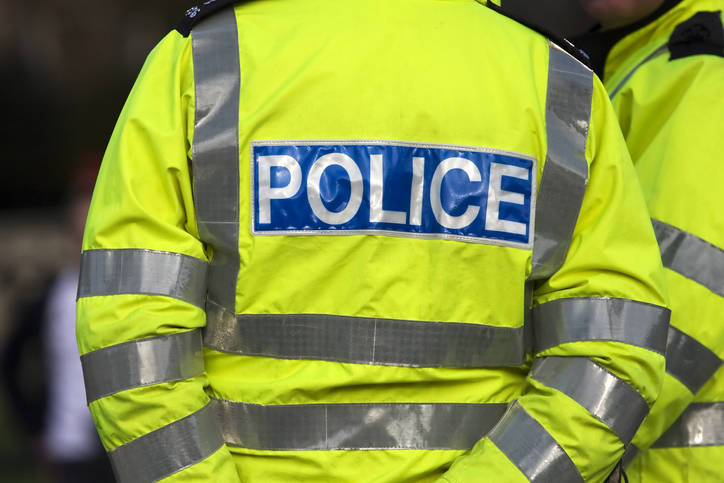 Policeman standing in uniform.