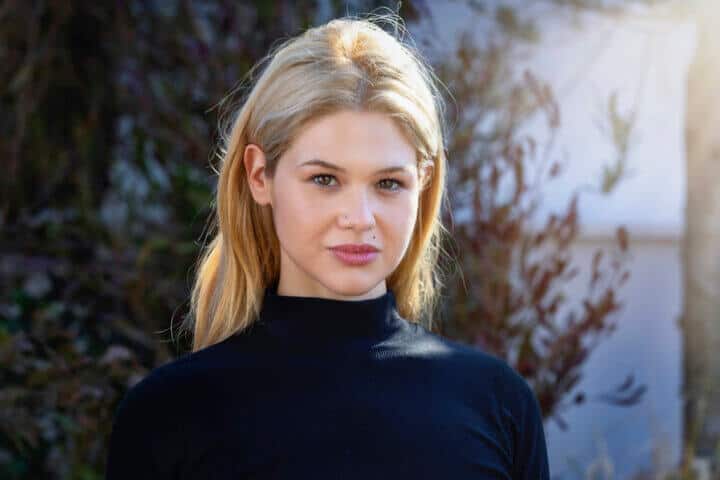 blonde woman staring at the camera
