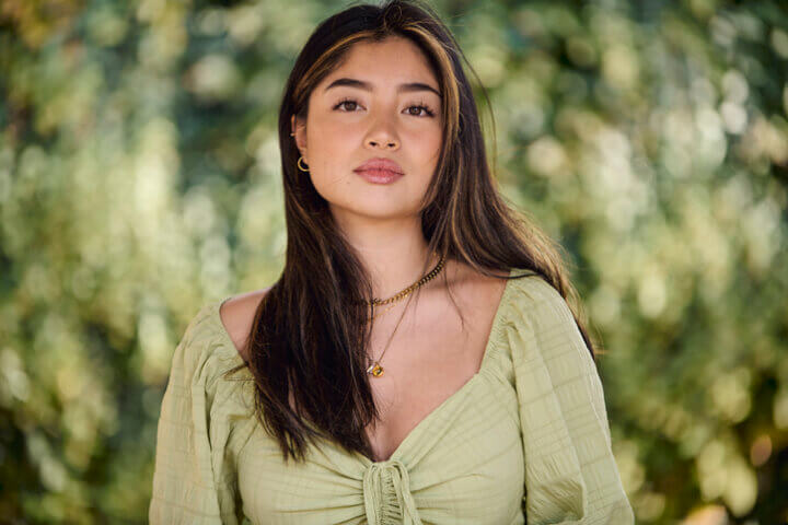 long haired brunette in greenery