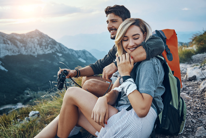 Couple embracing on a mountain top.