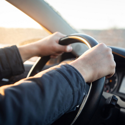 man driving car hands shot only