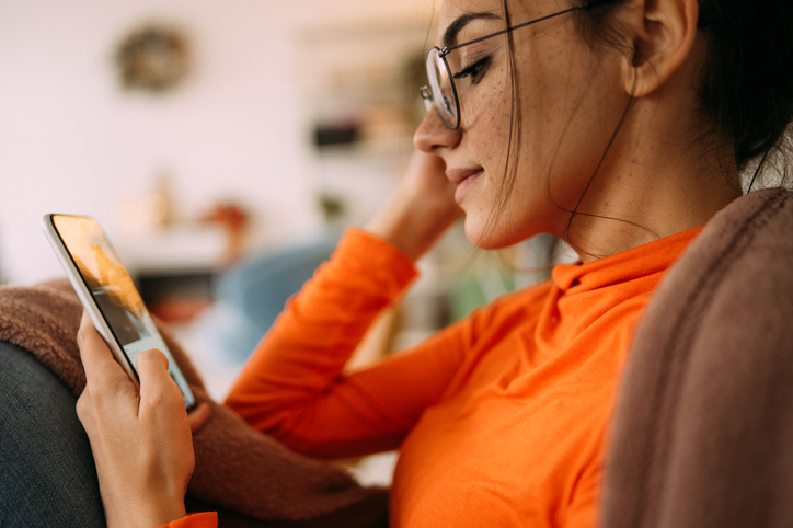 young woman checking social media on her phone