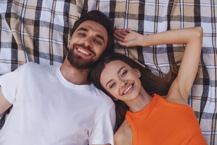 couple laid camera above