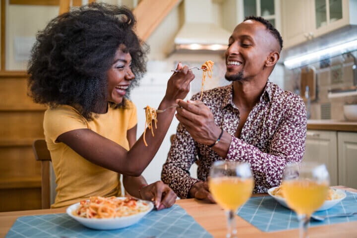 Couple enjoying romantic dinner of home cooked Pasta.