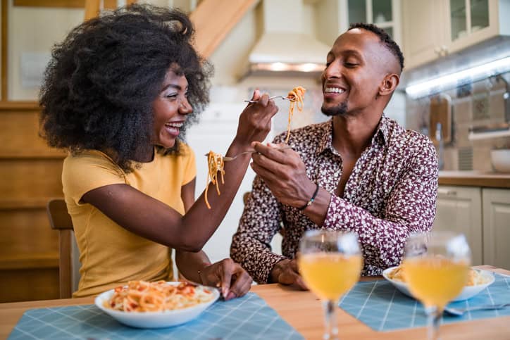 Couple enjoying romantic dinner of home cooked Pasta.