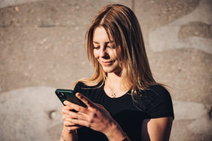 long haired attractrive woman using mobile