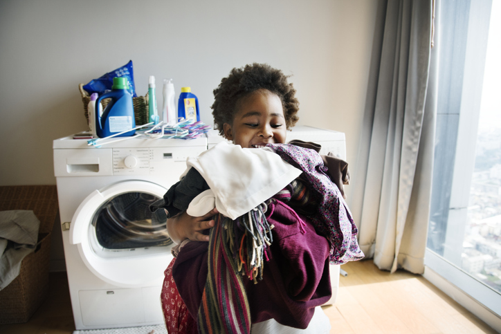 Young boy doing housework at home.