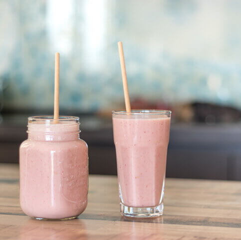 Two glasses of strawberry smoothie.