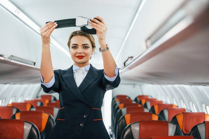 An airline flight attendant on a plane.