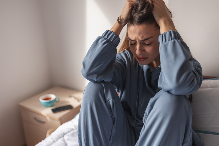 sad woman crying in bed