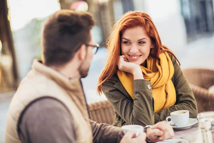 romantic couple outside having coffee
