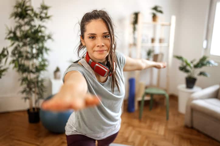 Healthy woman doing exercise at home.