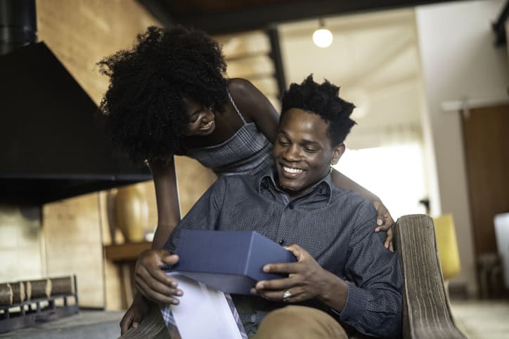 Husband and wife smiling. 