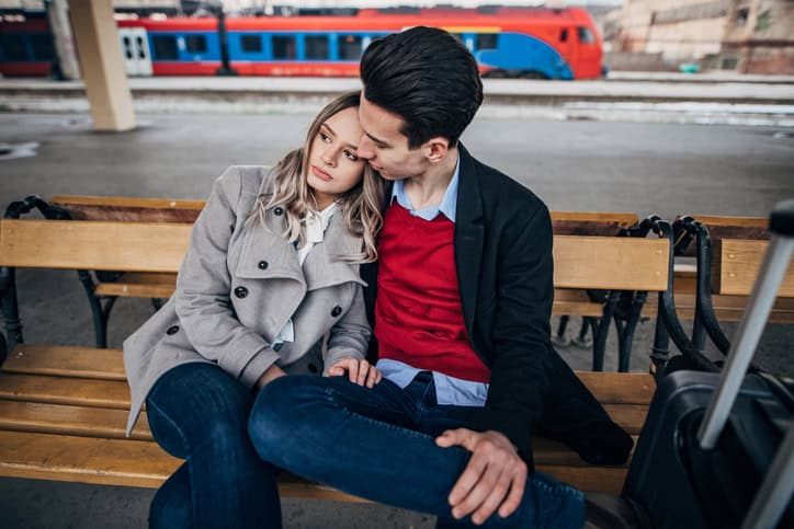woman sad leaning on man's shoulder
