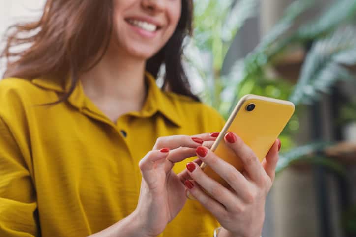 woman in yellow texting