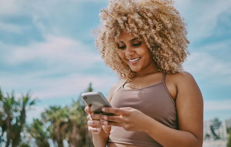 Young woman using a phone in the city.