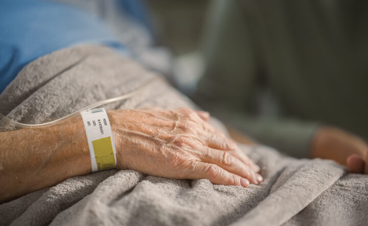 Woman in a hospital bed.