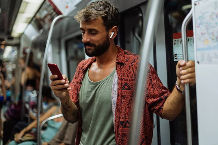 guy texting on subway
