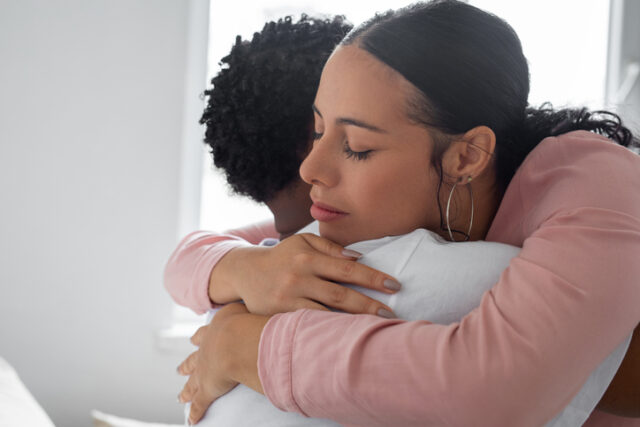 couple hugging at home
